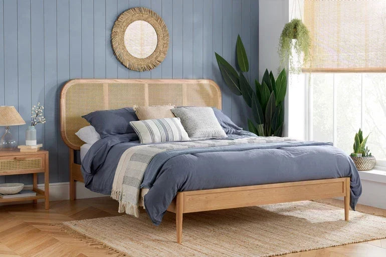 Rattan bed in a blue bedroom