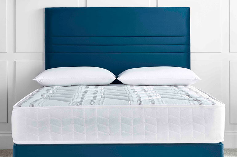 Deep Sleep Deluxe Orthocare Mattress on blue divan base with headboard