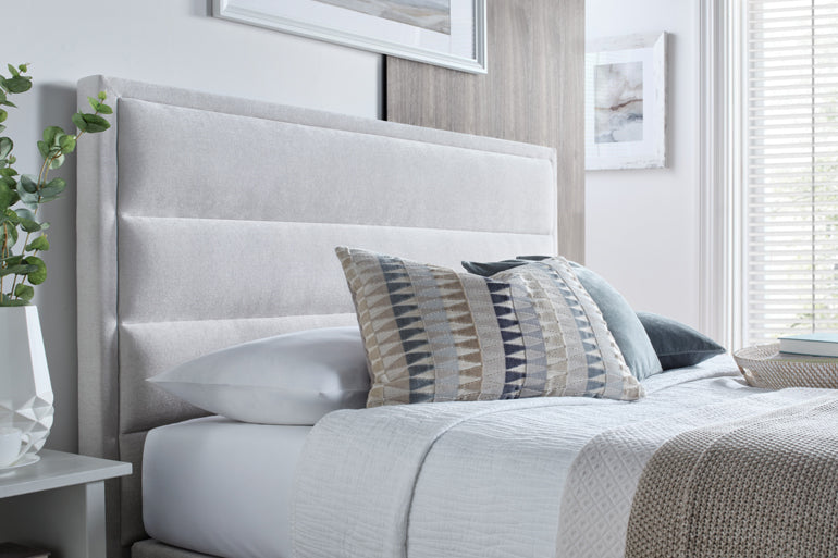 Close-up of Kaydian Kirkby Ottoman Bed in Maskat Clay with decorative pillows on bed.
