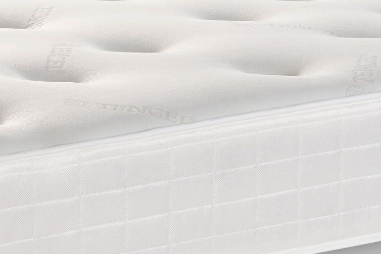 Close-up of a white mattress with visible stitching details