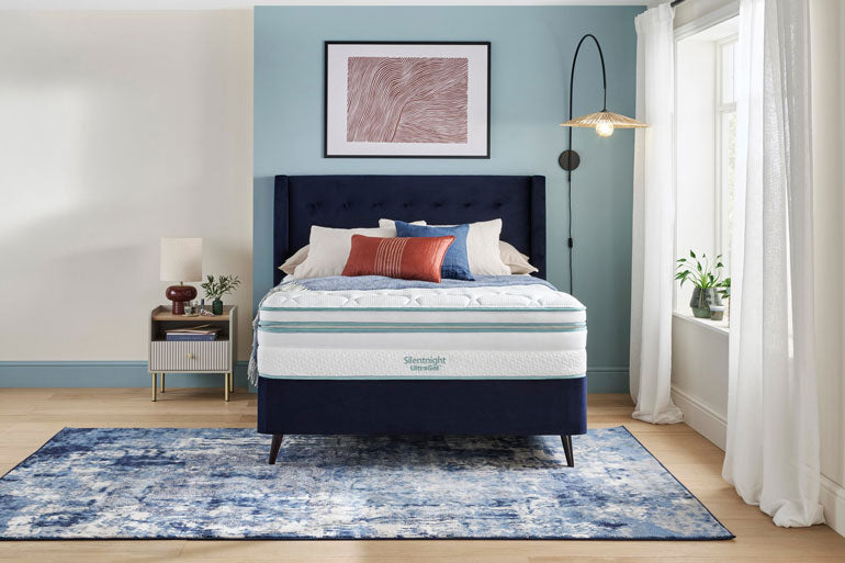 Bed with blue headboard and Silentnight UltraGel 3000 Boxtop mattress in a bedroom setting.