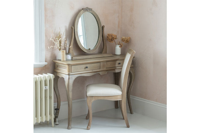 Willis & Gambier Camille Dressing Table with mirror and chair in a room with pink walls and white floor.