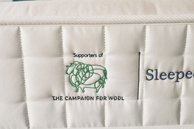 White quilted fabric with 'Supporters of the Campaign for Wool' logo and text.