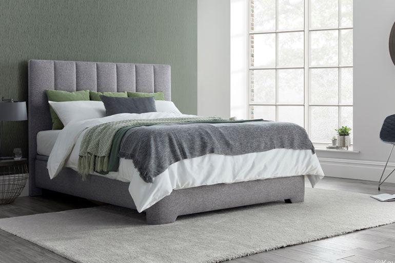 A Kaydian Medburn Ottoman Bed, neatly made bed with white and green bedding.