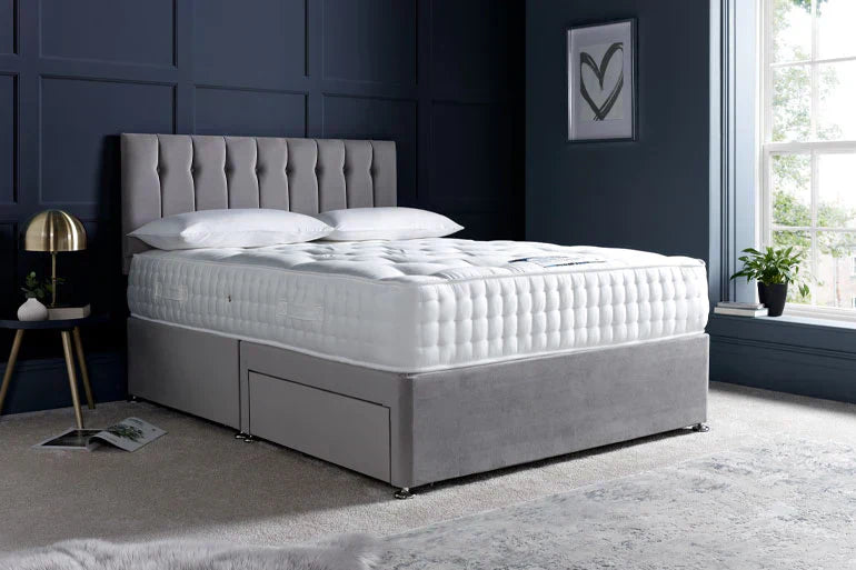 Fabric storage bed in grey against a blue navy wall