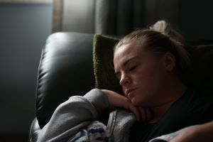 a young woman asleep on a sofa