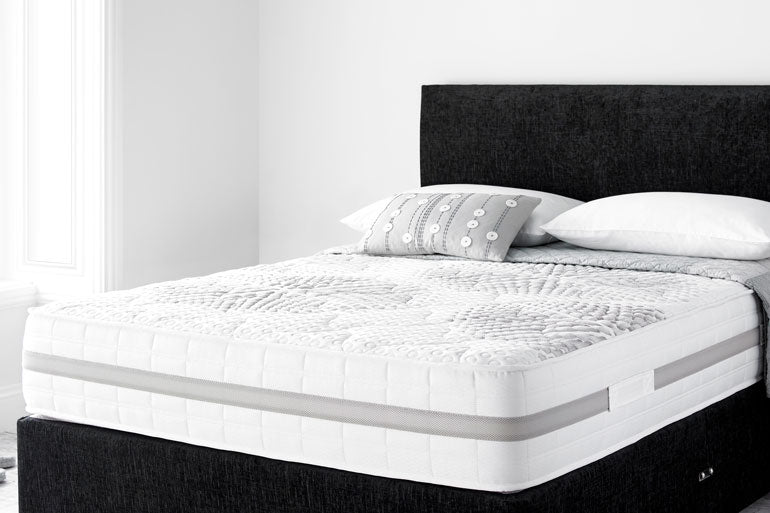 Giltedge Tranquilty Mattress on a bed with pillows in a minimalistic bedroom setting