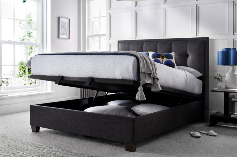 Kaydian Falfield Ottoman bed in slate with storage compartments in a bedroom setting.