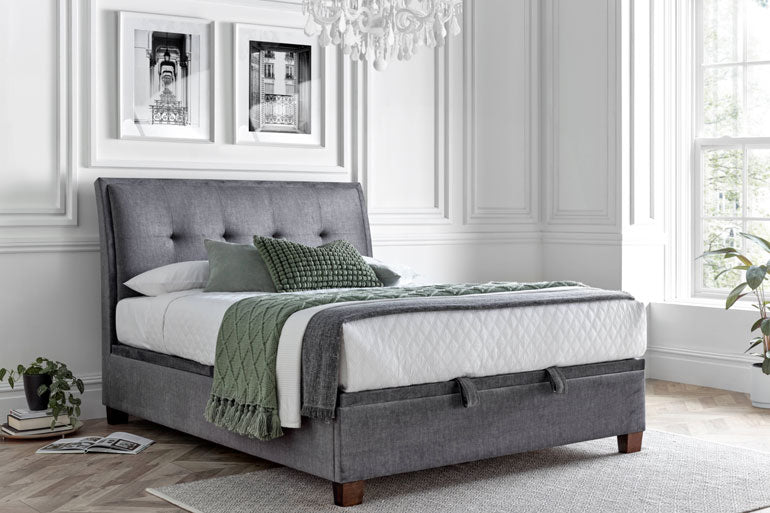 Kaydian Accent Ottoman Bed Vogue Grey in luxurious bedroom with green throw and cushions.