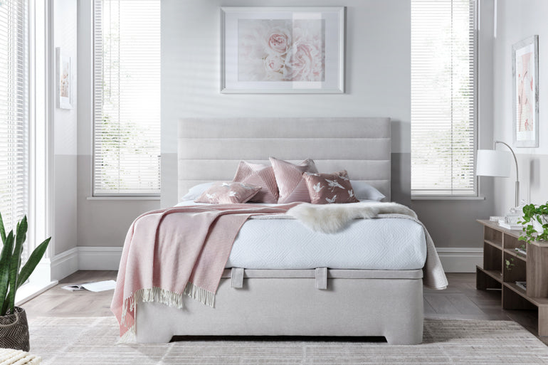 Kaydian Appleby Ottoman Bed in Maskat Clay styled with pink throw and pillows.