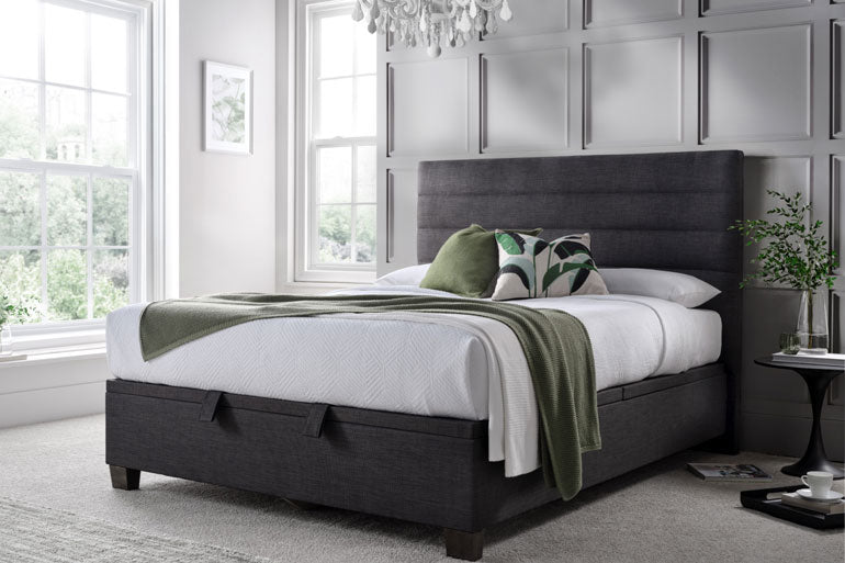 Bedroom with a Kaydian Appleford Ottoman bed, white bedding, and decorative pillows.