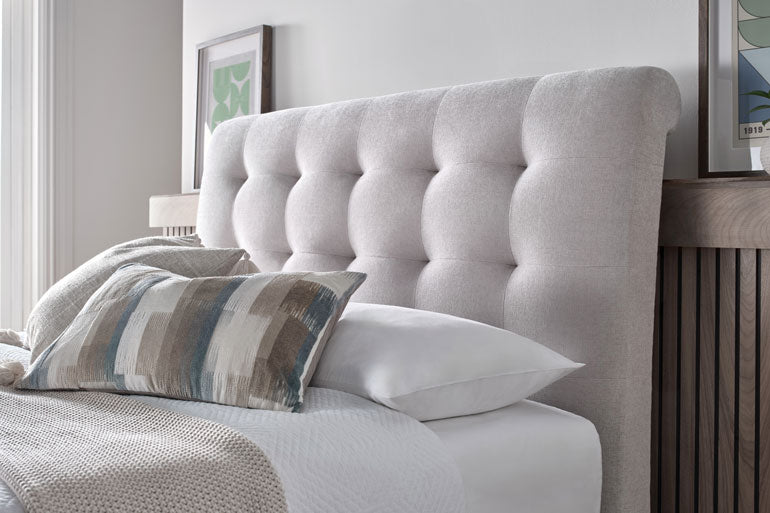 Kaydian Ashbrooke Ottoman headboard with pillows and bedding in a bedroom setting.