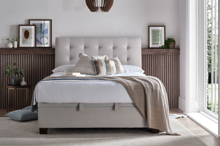 Bedroom with a neatly made bed featuring a the Kaydian Ashbrooke Ottoman Bed in Maskat Clay and white bedding.