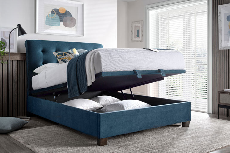 Kaydian Ashbrooke Ottoman Bed in Vogue Ocean with storage open in a bedroom setting