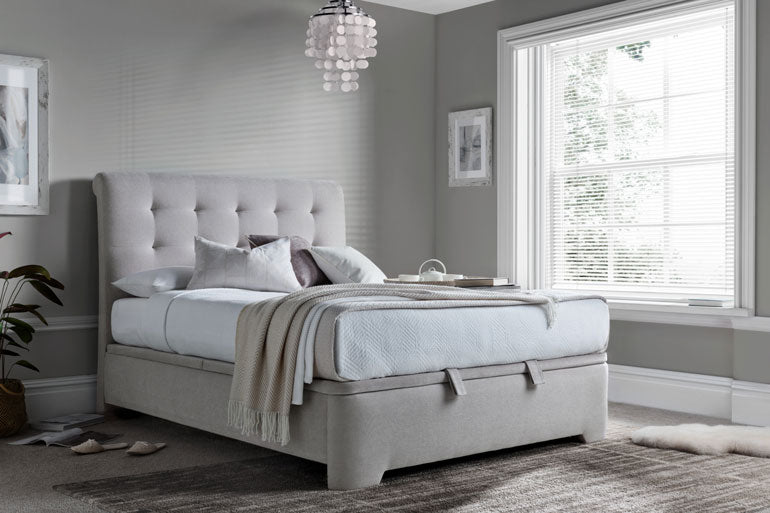 Kaydian Ashgrove Ottoman Bed in a bedroom with a window and decorative elements.