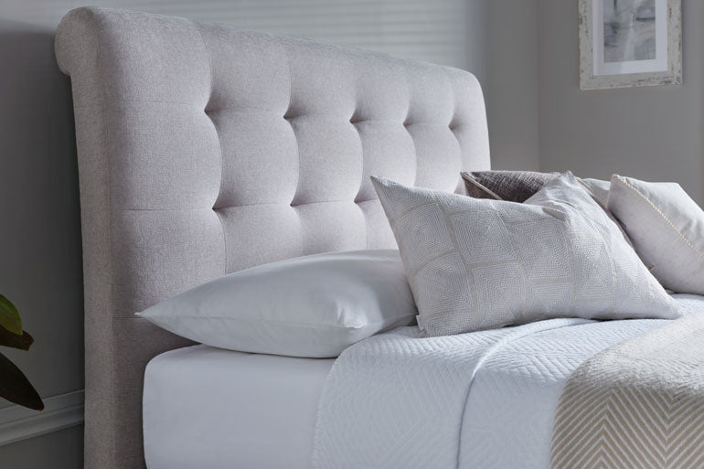 Kaydian Ashgrove Ottoman headboard with pillows on a bed in a bedroom setting
