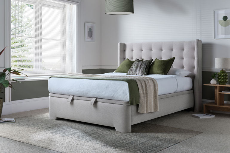 Kaydian Brunstock upholstered ottoman bed with green pillows in a bedroom setting