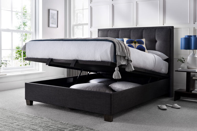 Kaydian Falfield Ottoman Bed in Slate with storage compartment open in a bedroom setting.