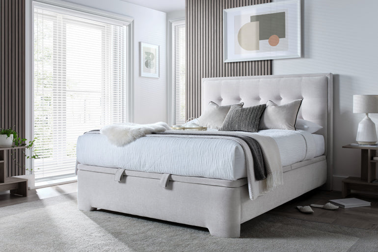 Modern bedroom with a Kaydian Falstone Ottoman Bed in Maskat Clay, nightstands, and light decor.