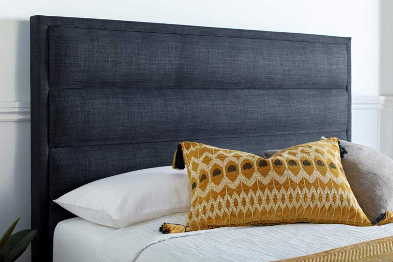 Close-up of Kaydian Kirkby | Kirkley TV Ottoman Bed in Slate with decorative pillows.