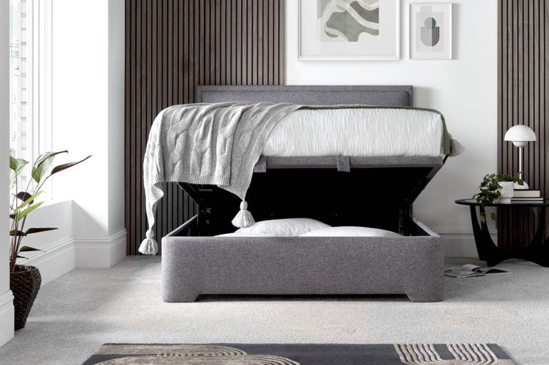 Kaydian Kirkby Ottoman Bed with the storage compartment slightly open in bedroom setting.