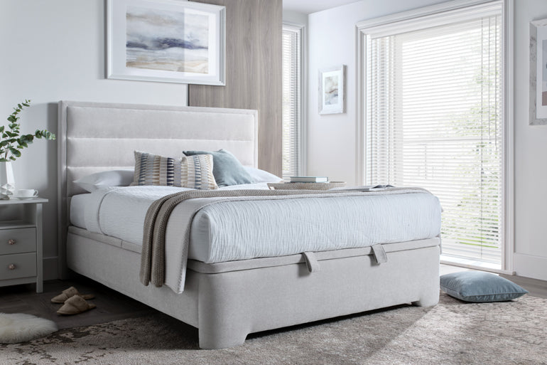Kaydian Kirkby Ottoman Bed in Maskat Clay in bedroom setting with white bedding.