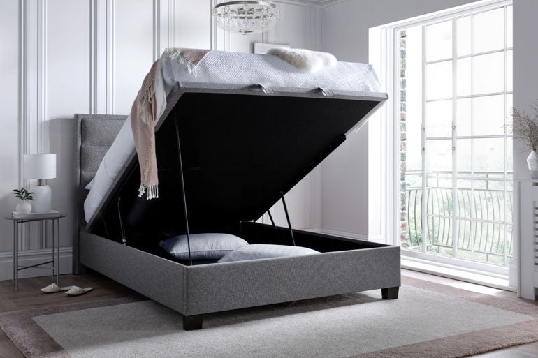 Kaydian Kirkland Ottoman Bed in Marbella Grey with storage compartment in a bedroom setting