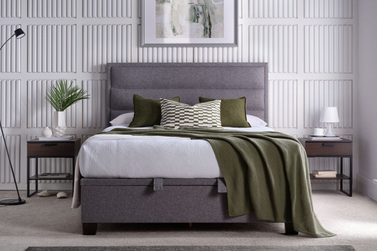 Kaydian Kirkland Ottoman Bed in Marbella Greywith green bedding in a modern bedroom setting.