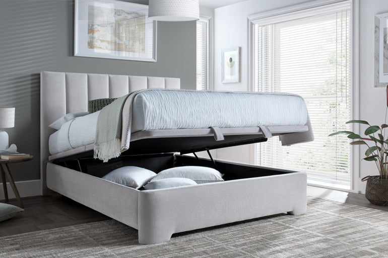 Kaydian Medburn Ottoman Bed with storage compartment open in a bedroom setting.