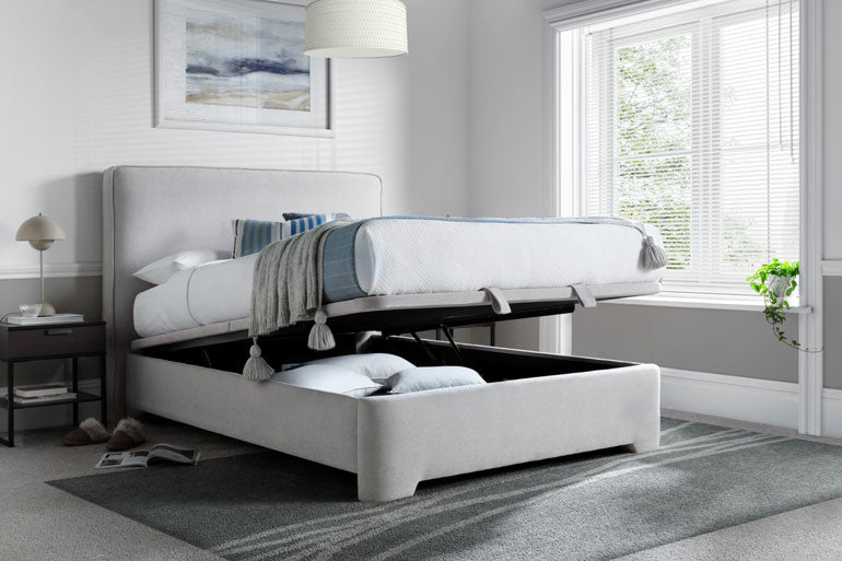 Kaydian Newland Ottoman Bed with storage compartment in a bedroom setting.