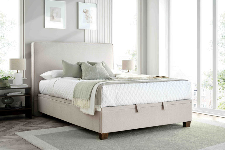 Kaydian Newton Ottoman Bed in Maskat Clay in bedroom with white bedding.