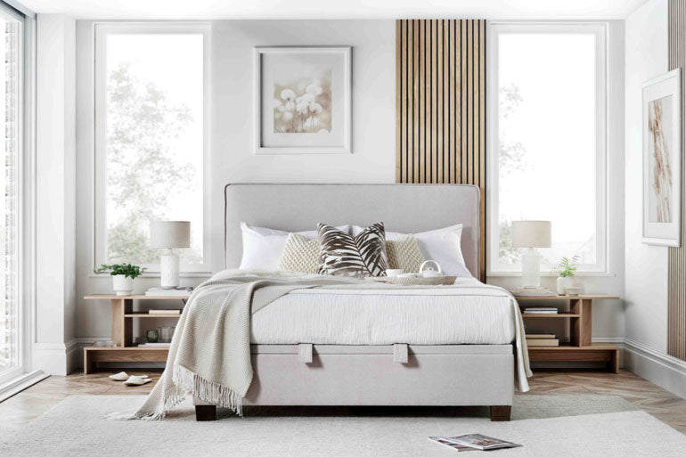 A Kaydian Newton Ottoman Bed with a high headboard, placed in a stylish bedroom setting.