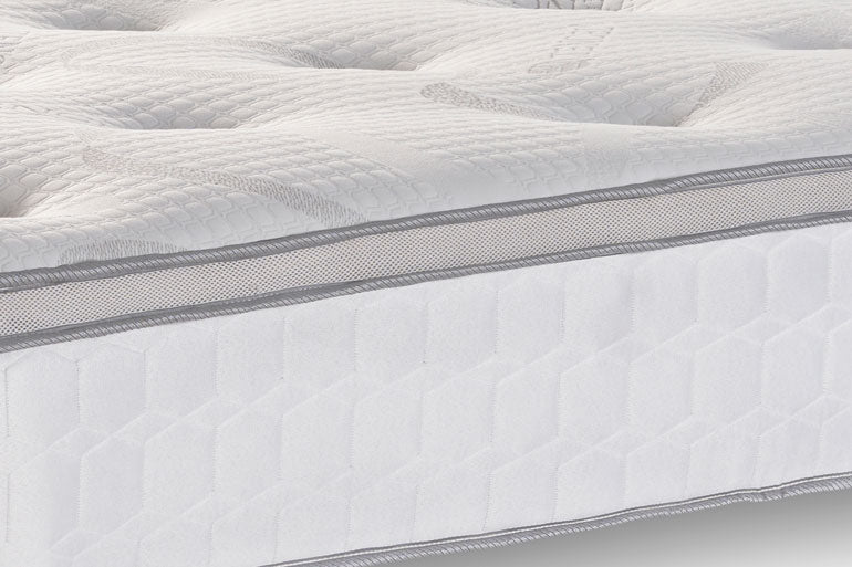 Close-up of a mattress with quilted surface and gray stitching detail
