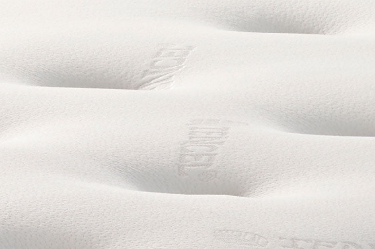 Close-up of a white mattress surface with visible stitching details.