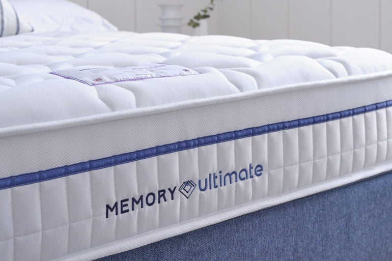 Memory Ultimate mattress with branding on a bed