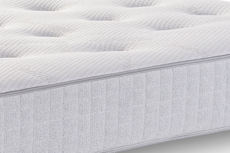 Close-up of a textured mattress surface with a gray border.