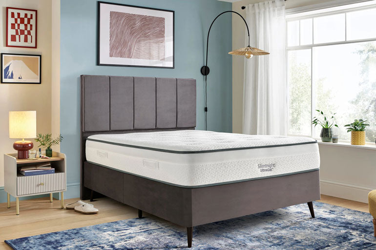 Bedroom with a Silentnight UltraGel 1400 Pocket Mattress on a bed frame, nightstand, and decor elements.