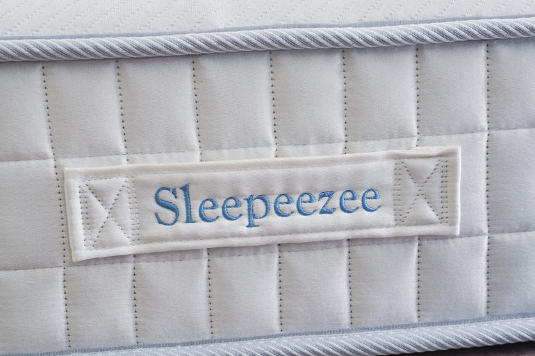 Mattress with 'Sleepeezee' label on a close-up view