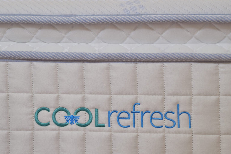 Mattress with 'Cool Refresh' logo on a beige background