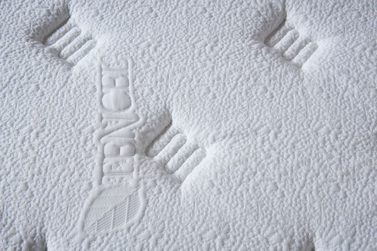 Close-up of a textured white mattress cover