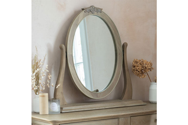 Willis & Gambier Camille oval mirror on a wooden dresser with decorative items.
