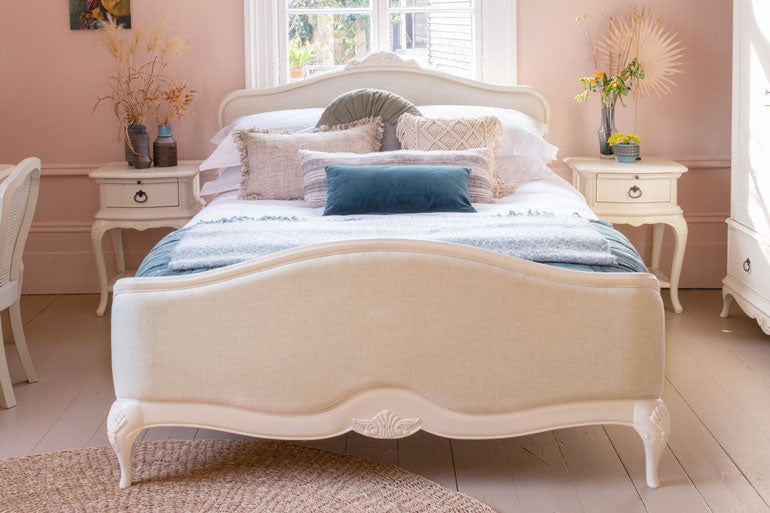 Neatly made Willis &amp; Gambier Ivory Upholstered Bed with decorative pillows in a bedroom setting.