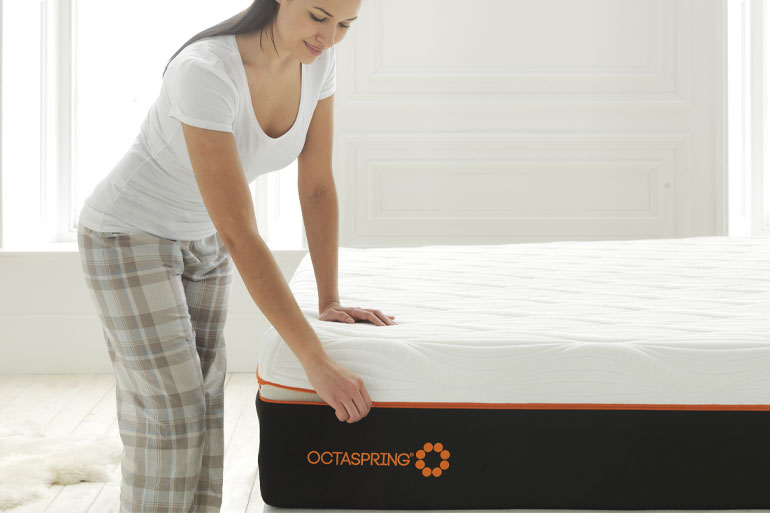 woman opening the cover on a Dormeo Octaspring 8500 Memory Foam Mattress
