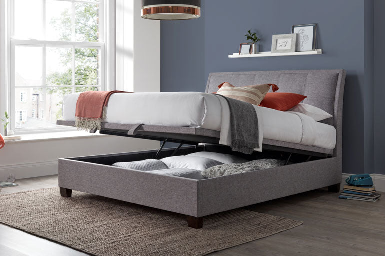 Kaydian Accent Ottoman Bed in Marbella Grey with storage compartment open.