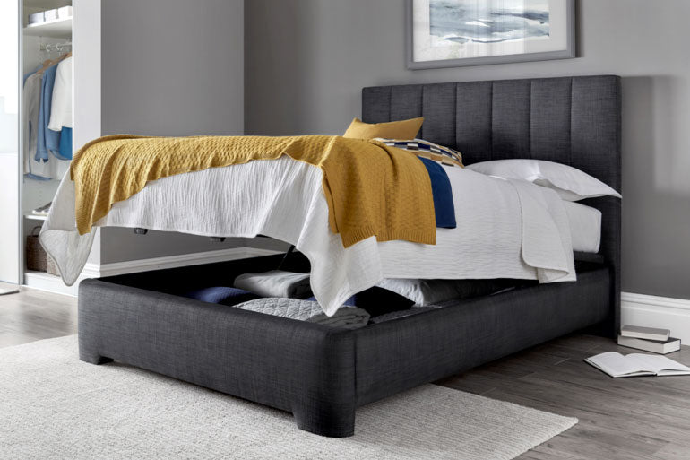 Kaydian Medburn Ottoman Bed in Slate in bedroom setting with storage compartment open.