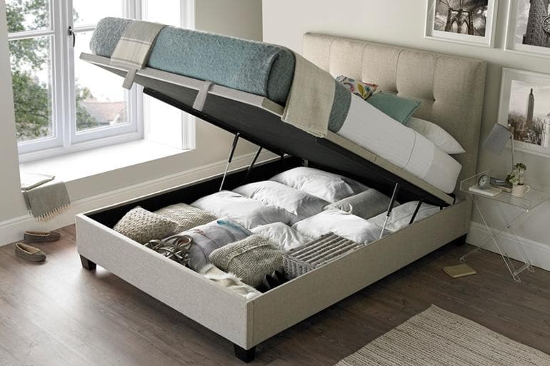 Kaydian Walkworth Ottoman Bed in Oatmeal with storage compartment open.